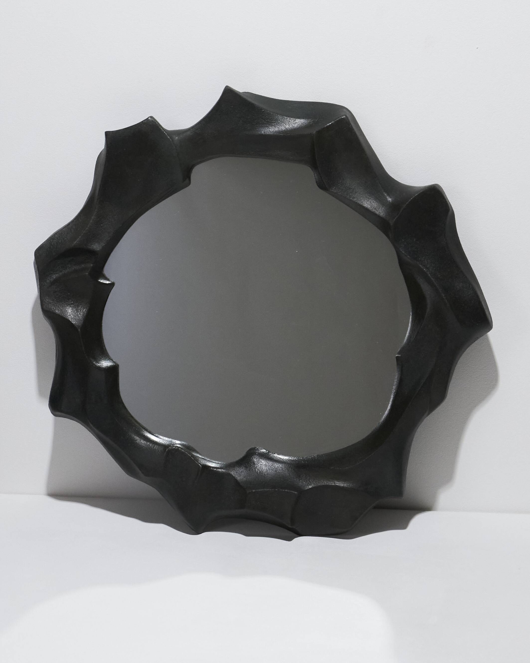Sculptural sandstone mirror