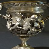 Carved silver bronze vase mounted on marble pedestal
