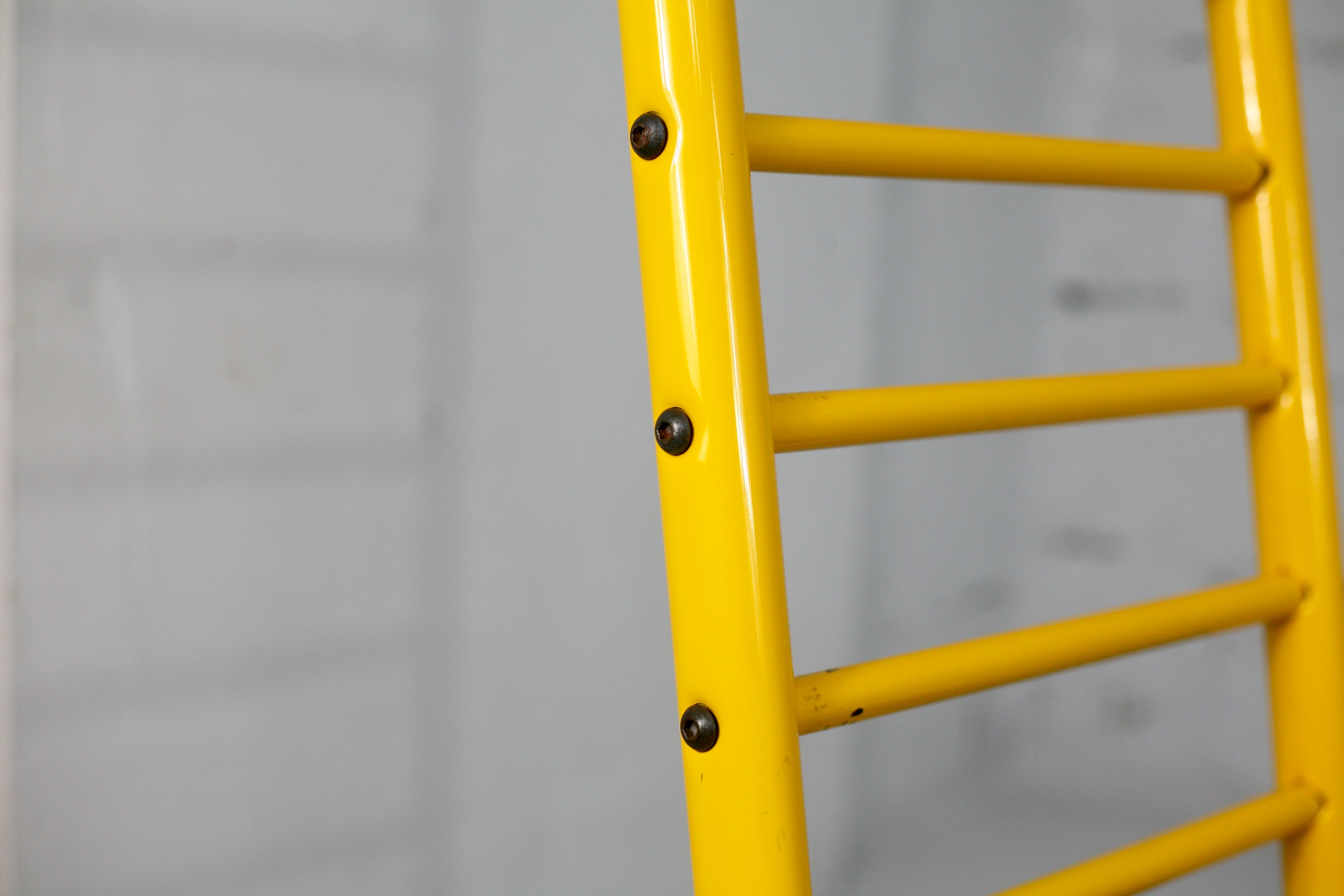Adjustable seat chair. Circa 1980. Italy. Yellow lacquered steel.