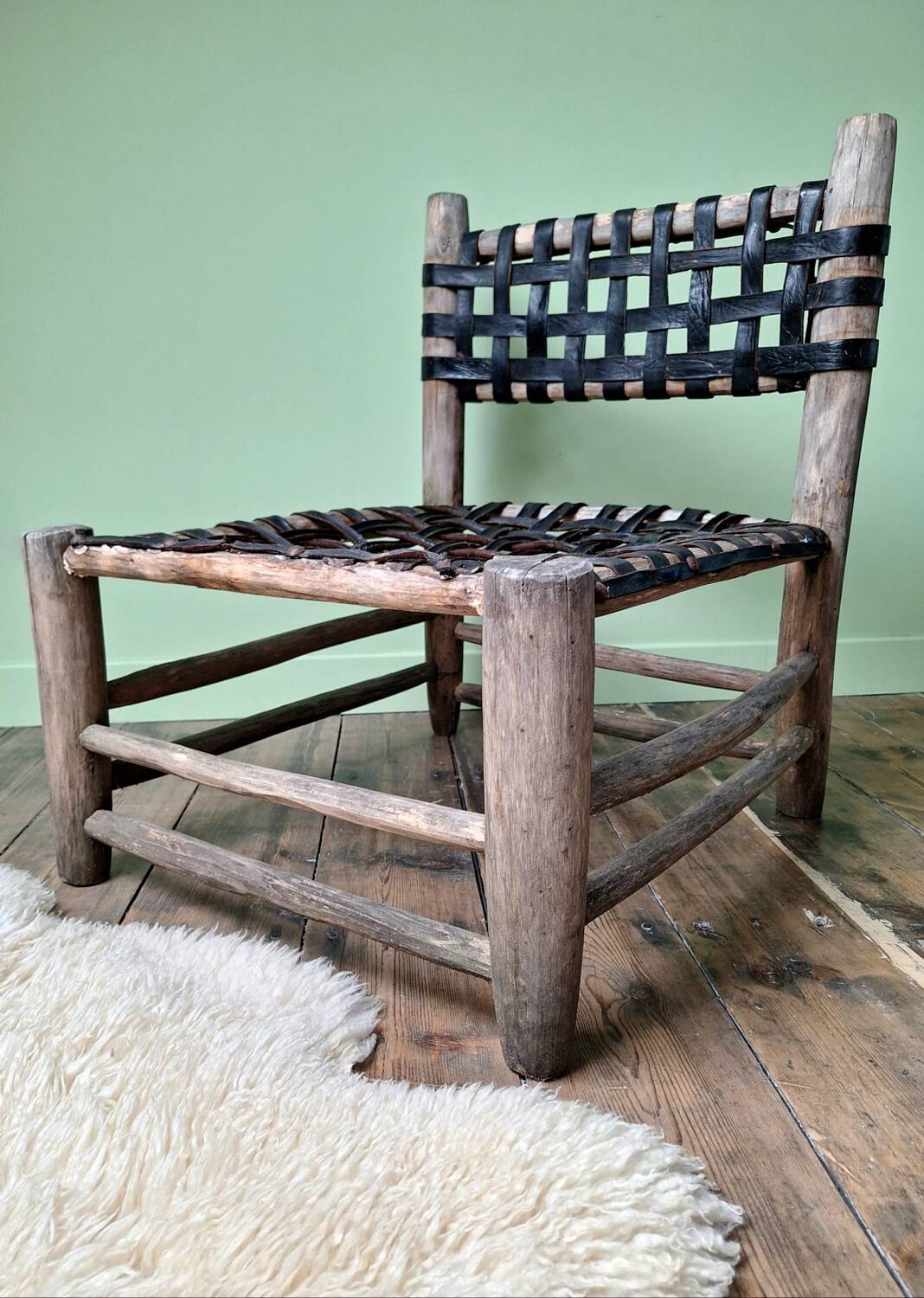 Vintage armchair in woven leather and wood