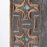 Indonesian construction element in carved wood with cross pattern in red, white geometric frieze
