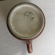 Vintage 70s old ceramic mug with a brown cubic graphic pattern.