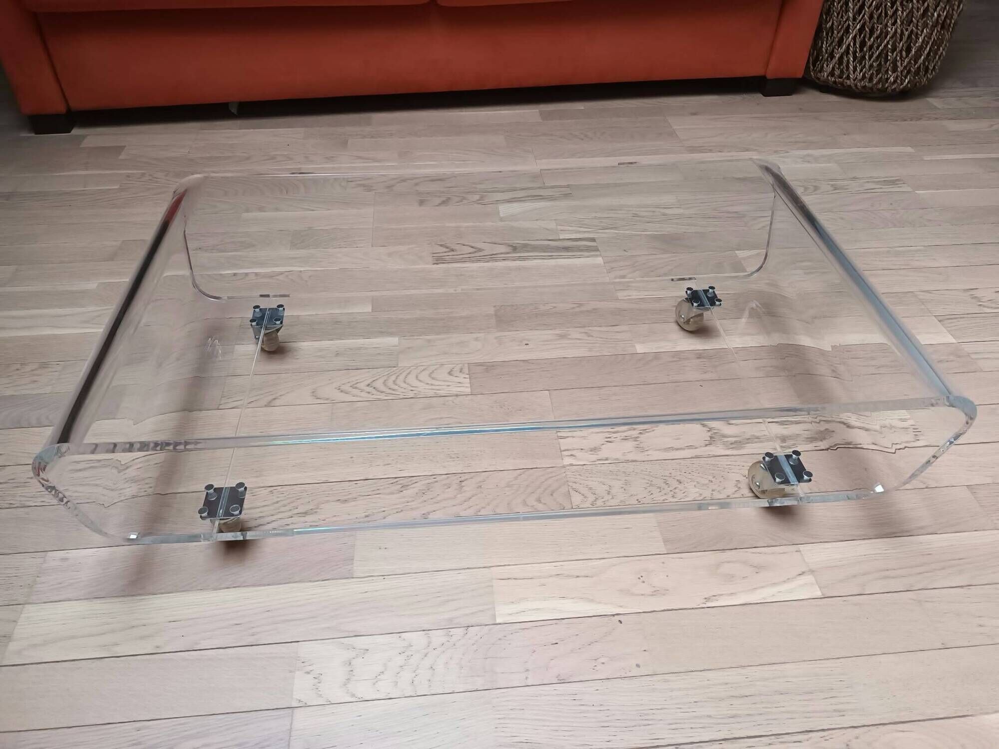 Design coffee table from Habitat in transparent plexiglass, mounted on wheels.