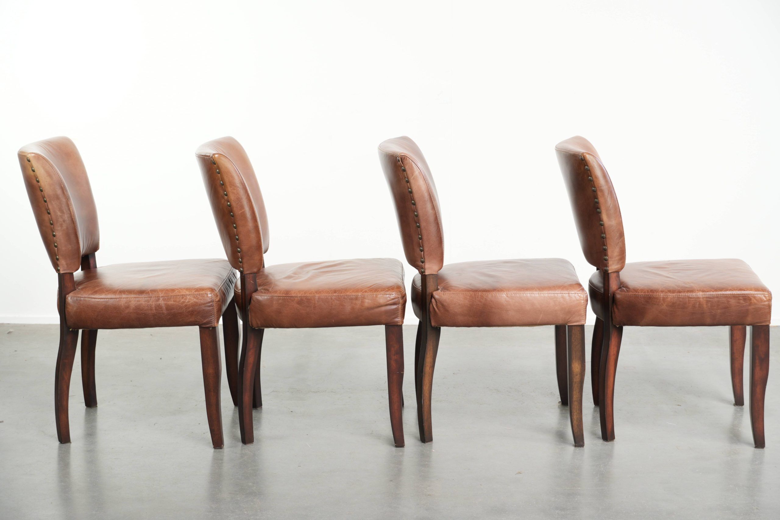 Set of 4 cognac-coloured cowleather dining chairs with decorative nails