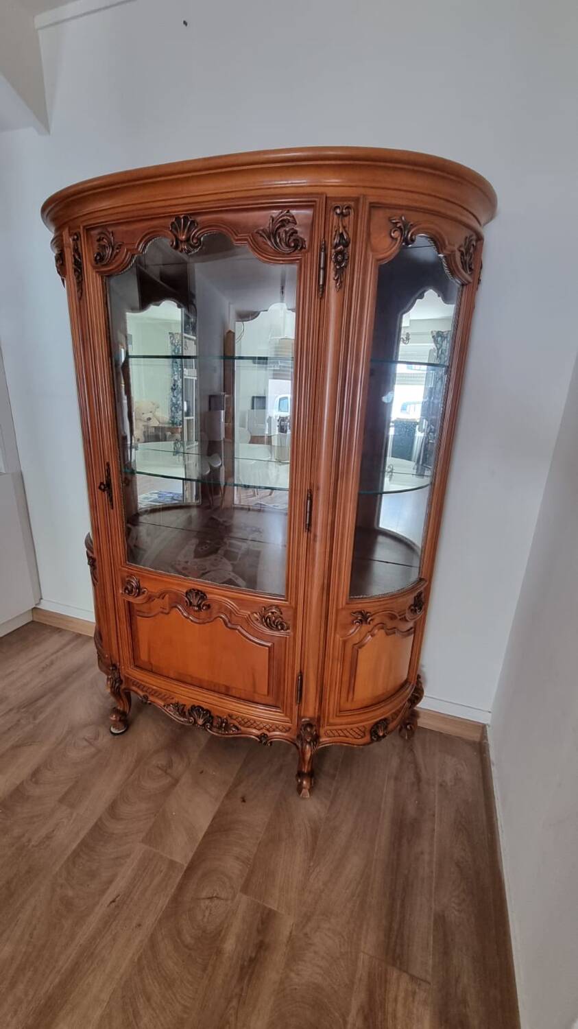 Silver display cabinet with a curved design.