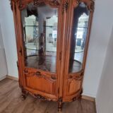 Silver display cabinet with a curved design.