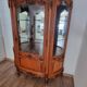 Silver display cabinet with a curved design.