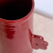 Handmade abstract ceramic vase with asymmetrical handles and burgundy flower