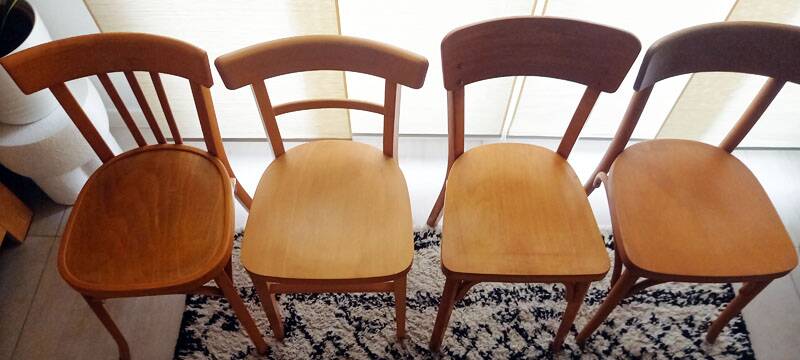 Set of 4 light wood bistro chairs stamped Baumann and Thonet.