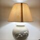 1980s ceramic table lamp with a wooden base and adjustable shade.