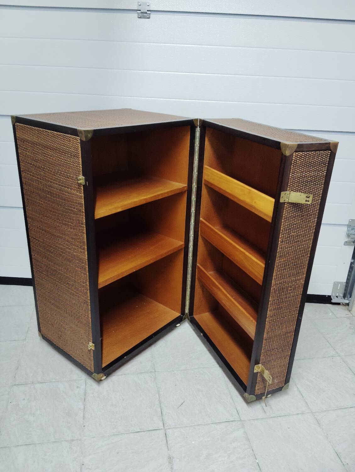 Wardrobe trunk on casters in mahogany and woven rattan.