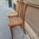 Pair of vintage bistro chairs in curved wood and caning.