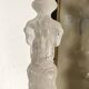 Tall molded glass candle holder with ram heads