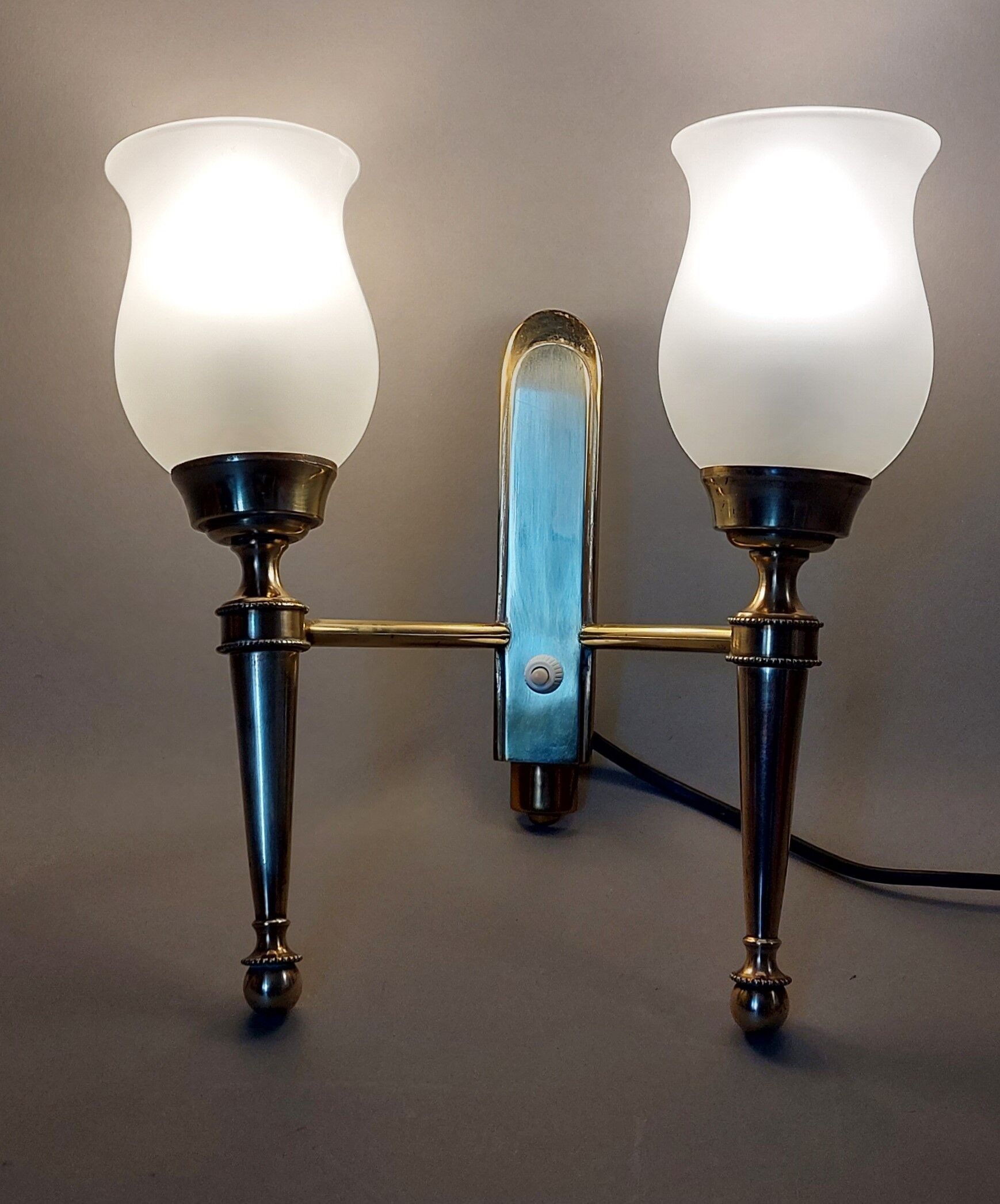 Neoclassical Torch two-arm wall lamp in solid brass, circa 1940
