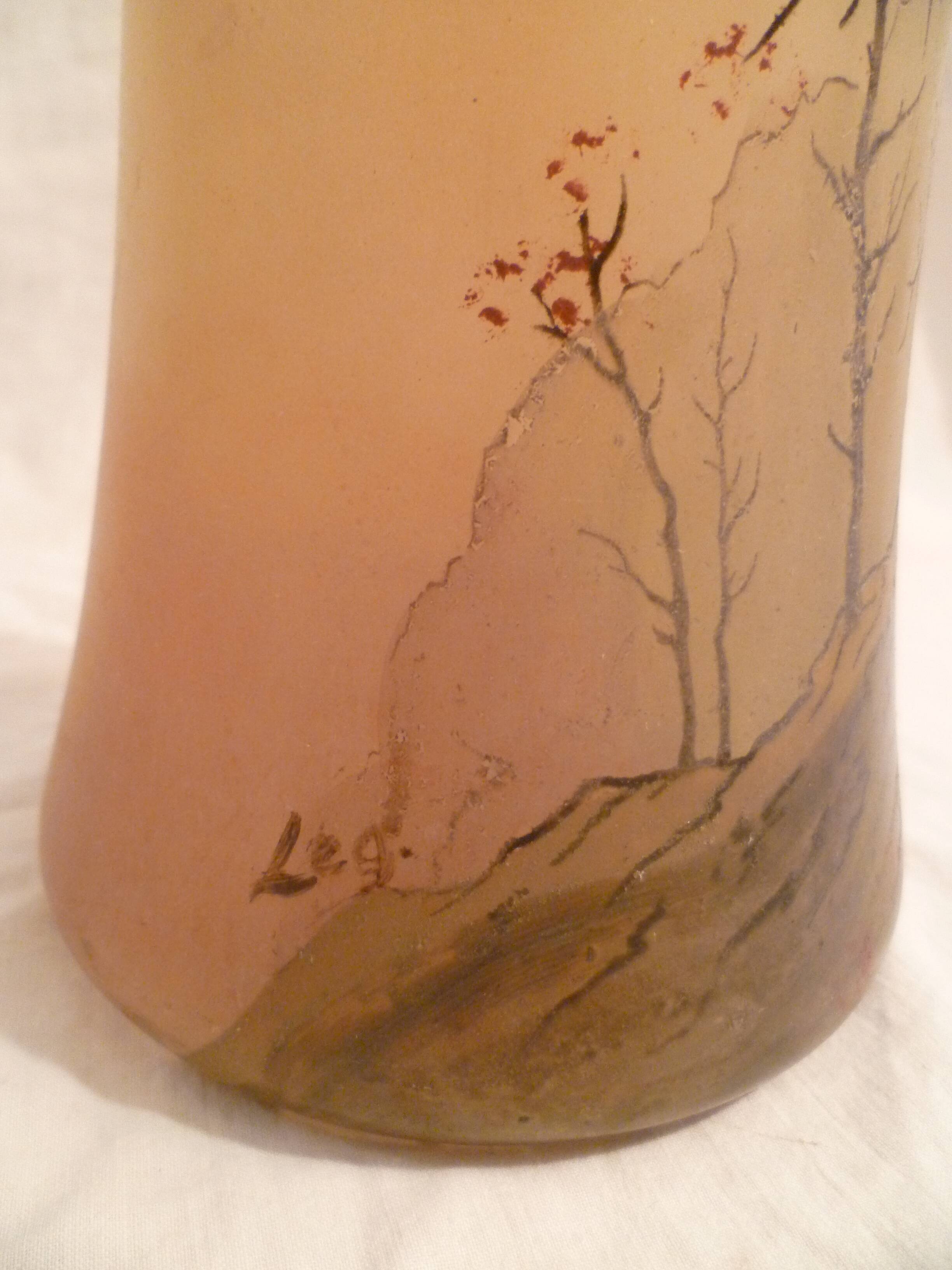 Blown glass vase with painted underbrush decoration marked "leg"