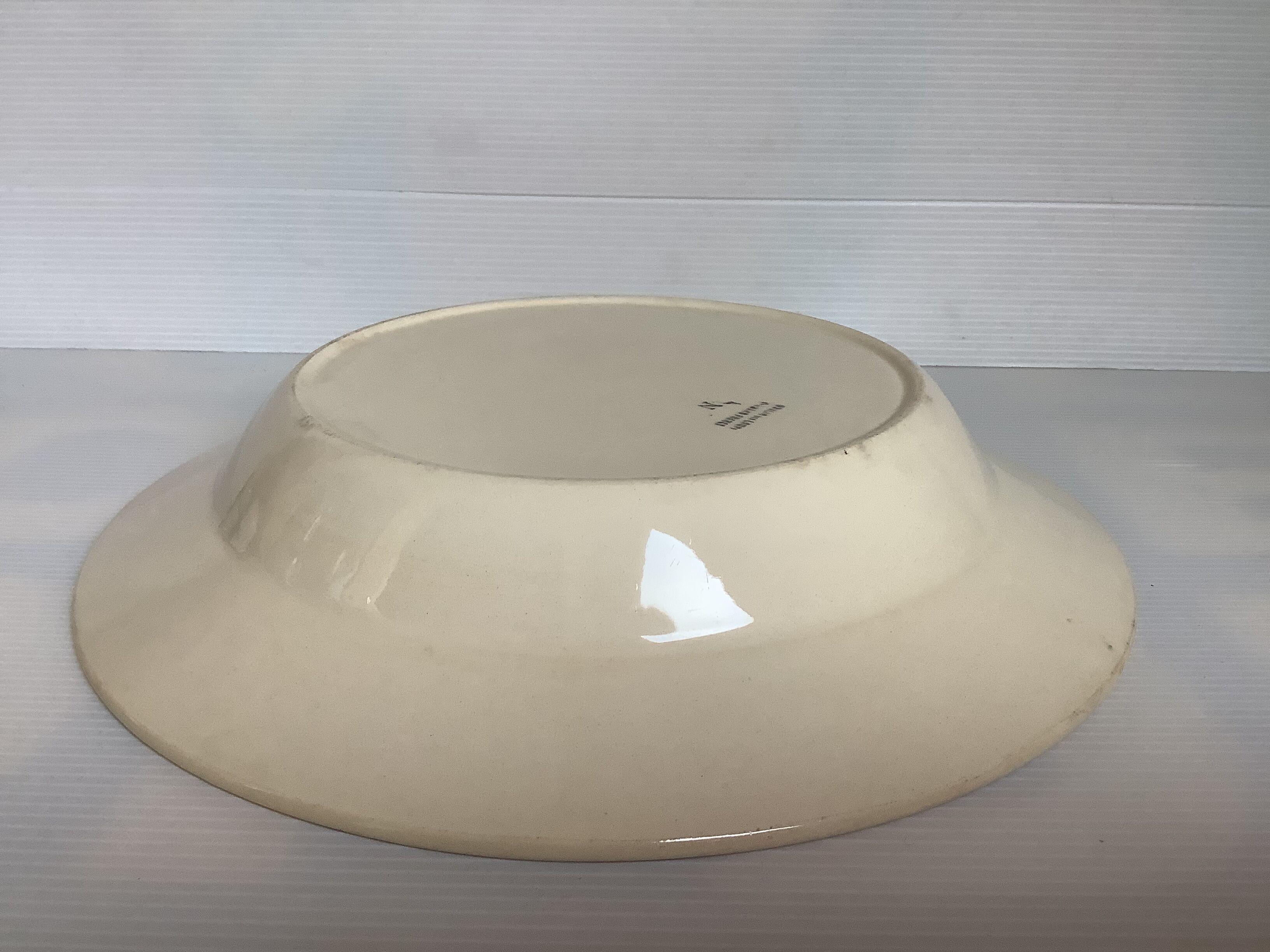 Earthenware plate from Moulin des Loups with stencil pattern.