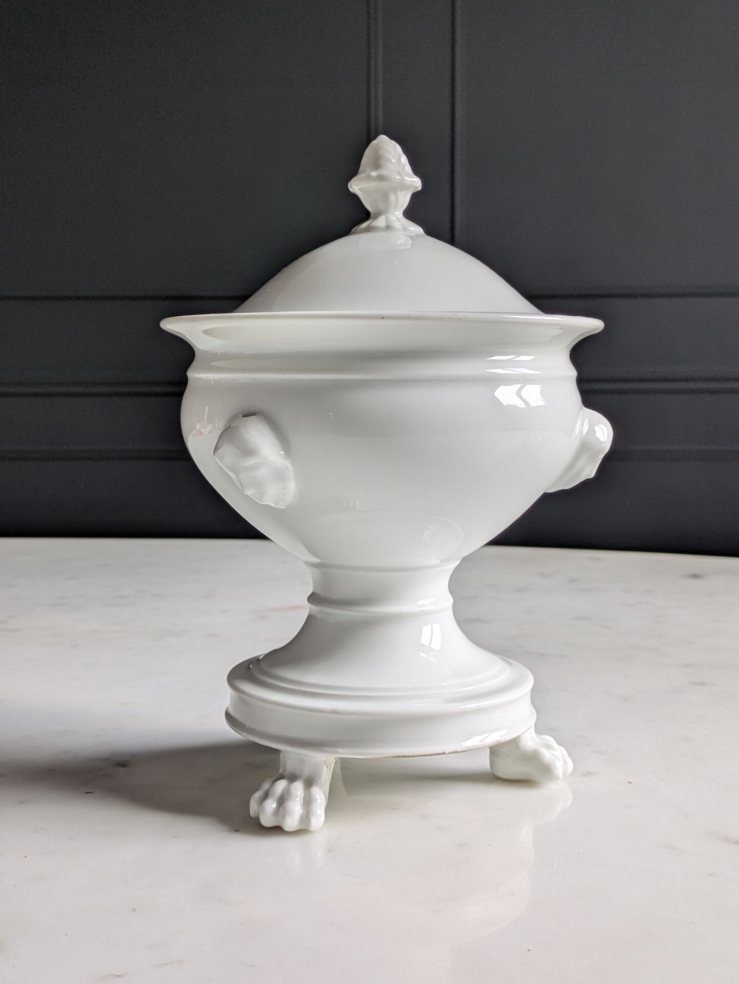 White porcelain confiturier with lion paws and masks. 19th century.