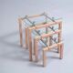 Three nesting tables from the 90s made of painted metal and tempered glass.