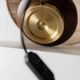 Lot of 2 vintage table lamps from the 1970s, dark wood oval bases with curved brass details, handmade natural fibre lampshades, elegant lighting.