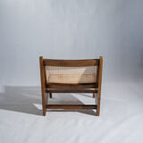 Reclined armchair in canned teak in natural wood