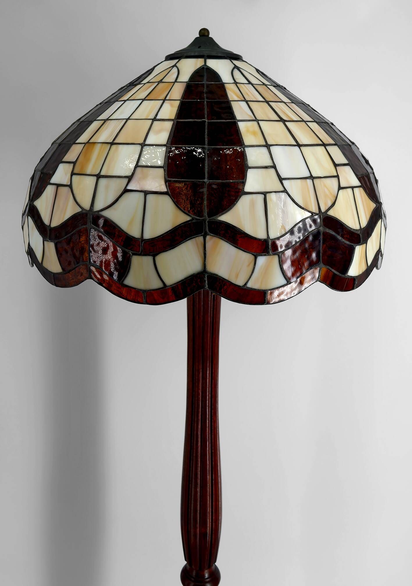 Art Deco floor lamp in carved walnut, stained glass shade, France, c. 1920
