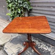 19th-century solid mahogany table with a tilting top and brass mechanism.