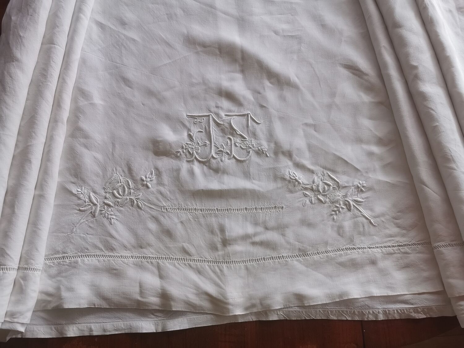 Antique embroidered linen sheet with a monogram.