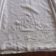 Antique embroidered linen sheet with a monogram.