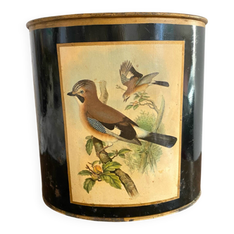 Metal wastebasket with bird decoration