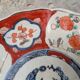 Antique Imari deep plate with red and blue floral decoration, 21.5cm.