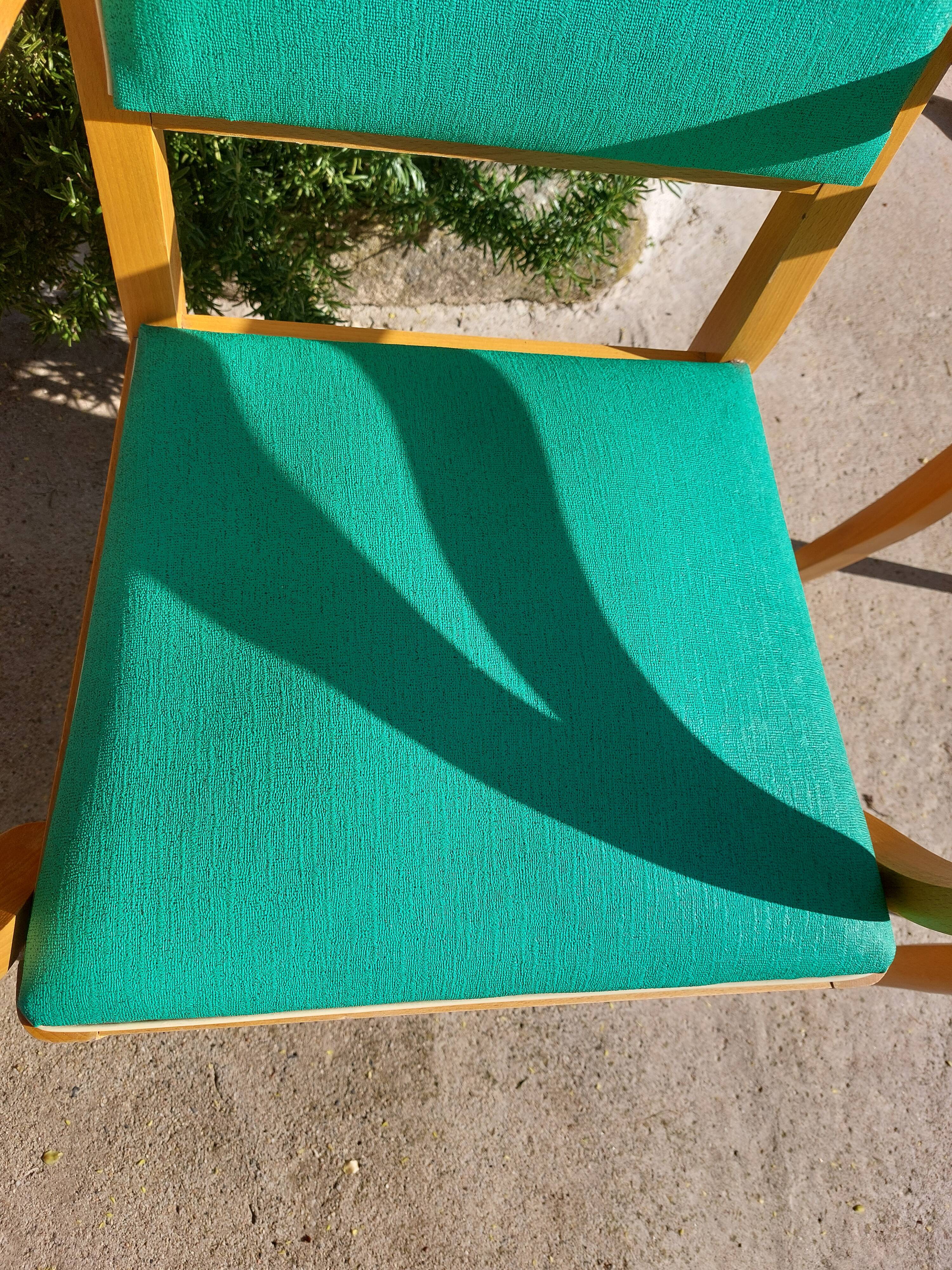 3 vintage bridge chairs with rounded armrests.