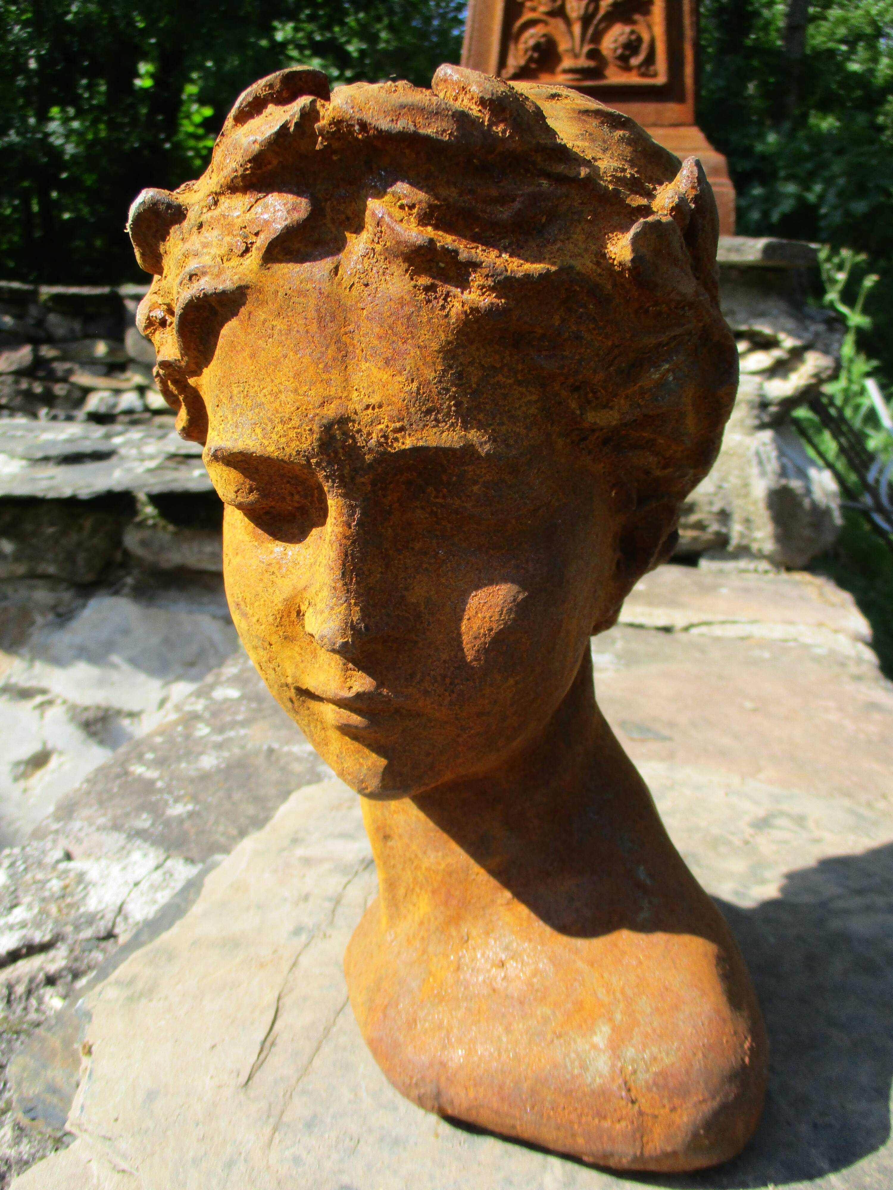 Cast iron sculpture of a woman.