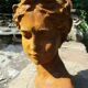 Cast iron sculpture of a woman.