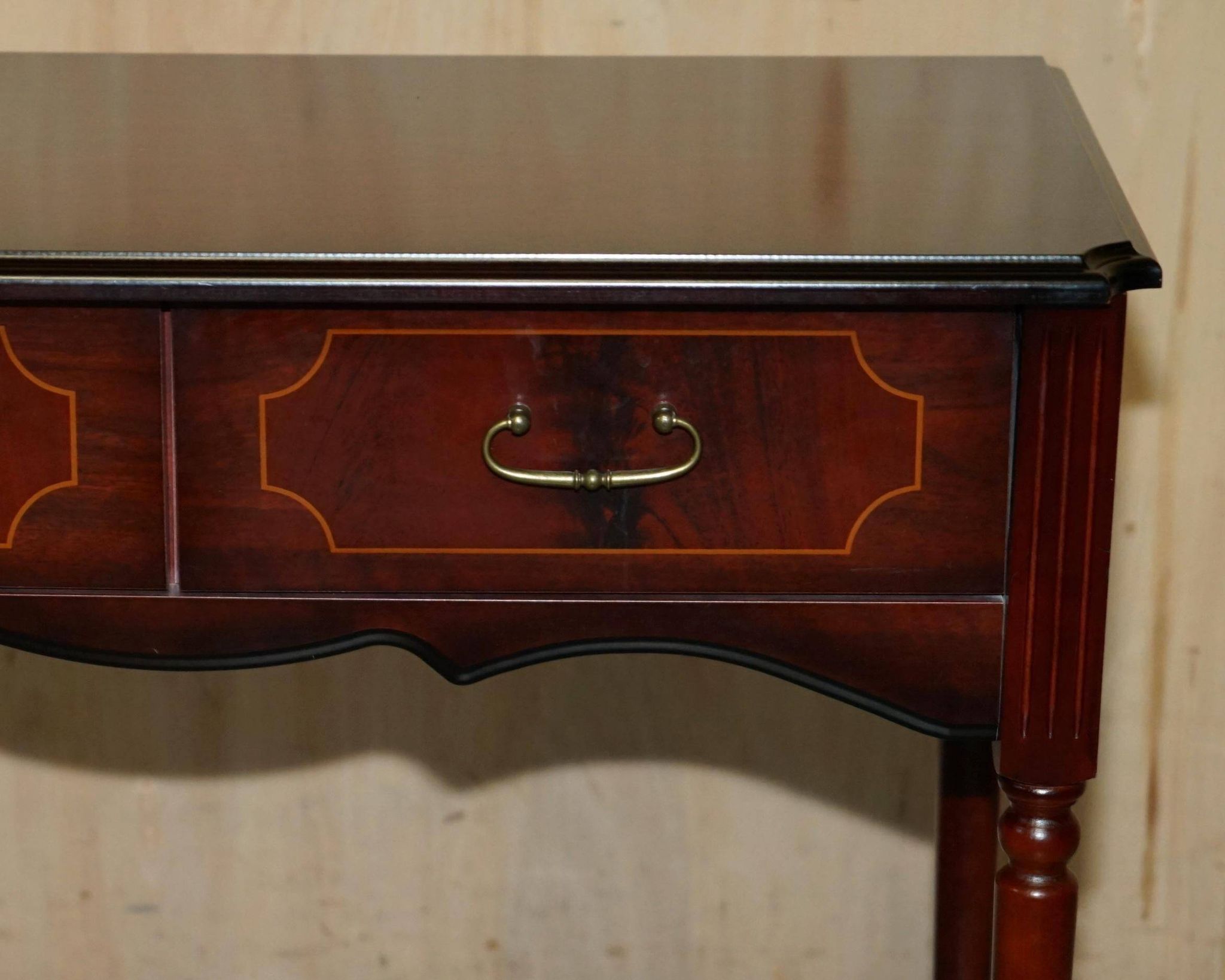 Small console with two drawers in hardwood finish.