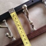 Coat rack, teak and brass coat hooks.