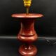 Lamp base in reconstituted stone, red "oxblood", 20th century
