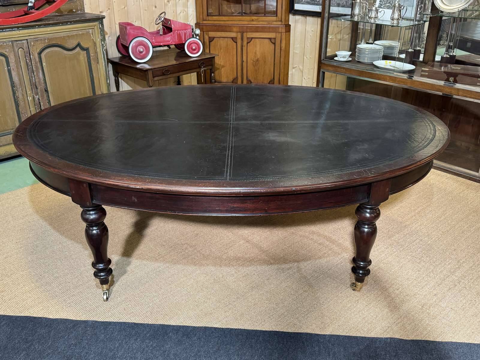 Large English library table in dark walnut with a leather top.