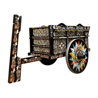 Sarchi Costa Rica, painted wooden cart with polychrome decorations on a black background