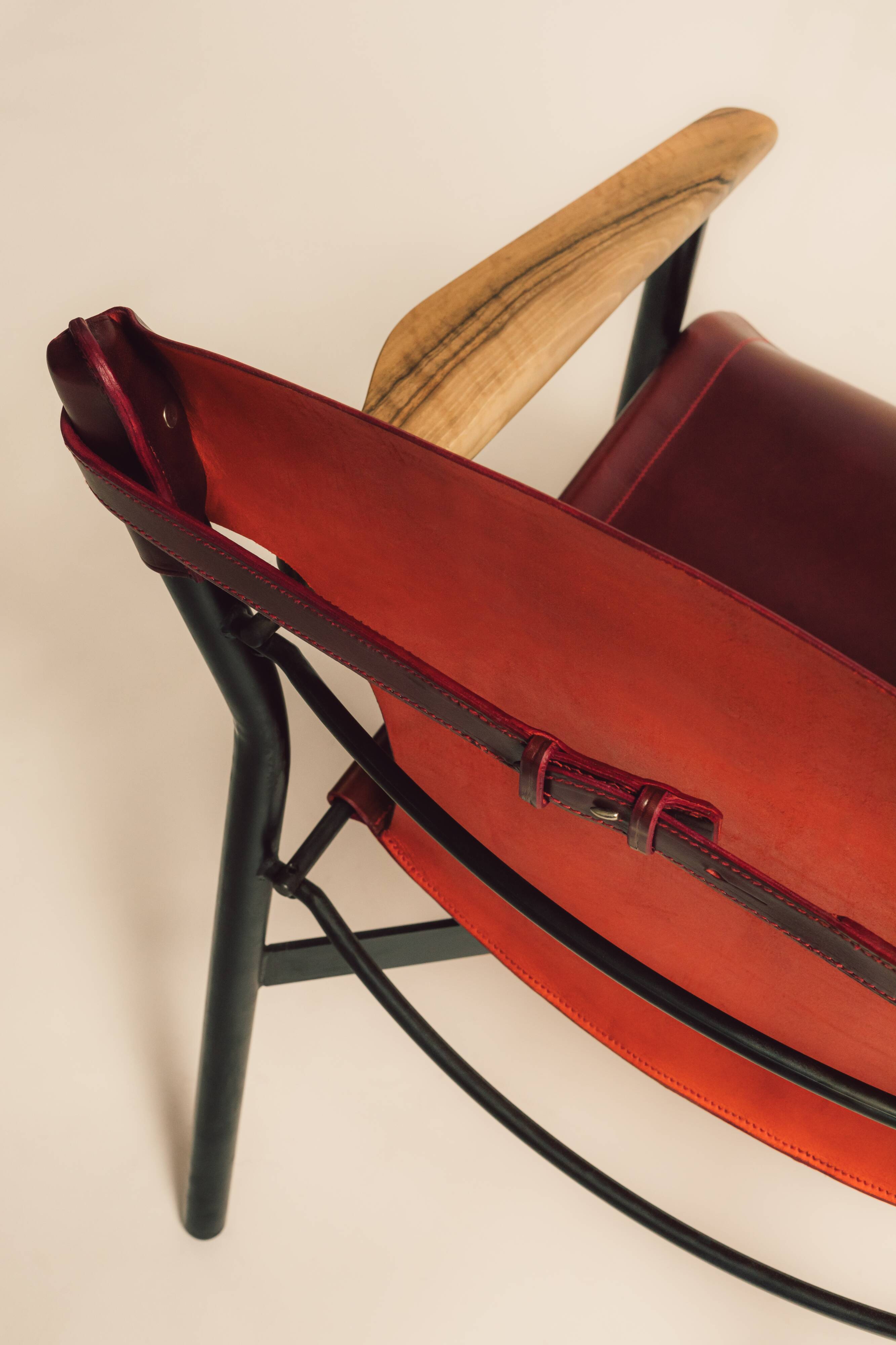 Maërl armchair, Galathée model, red leather, solid wood armrests of your choice