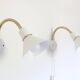Pair of Scandinavian wall sconces, white and gold metal.