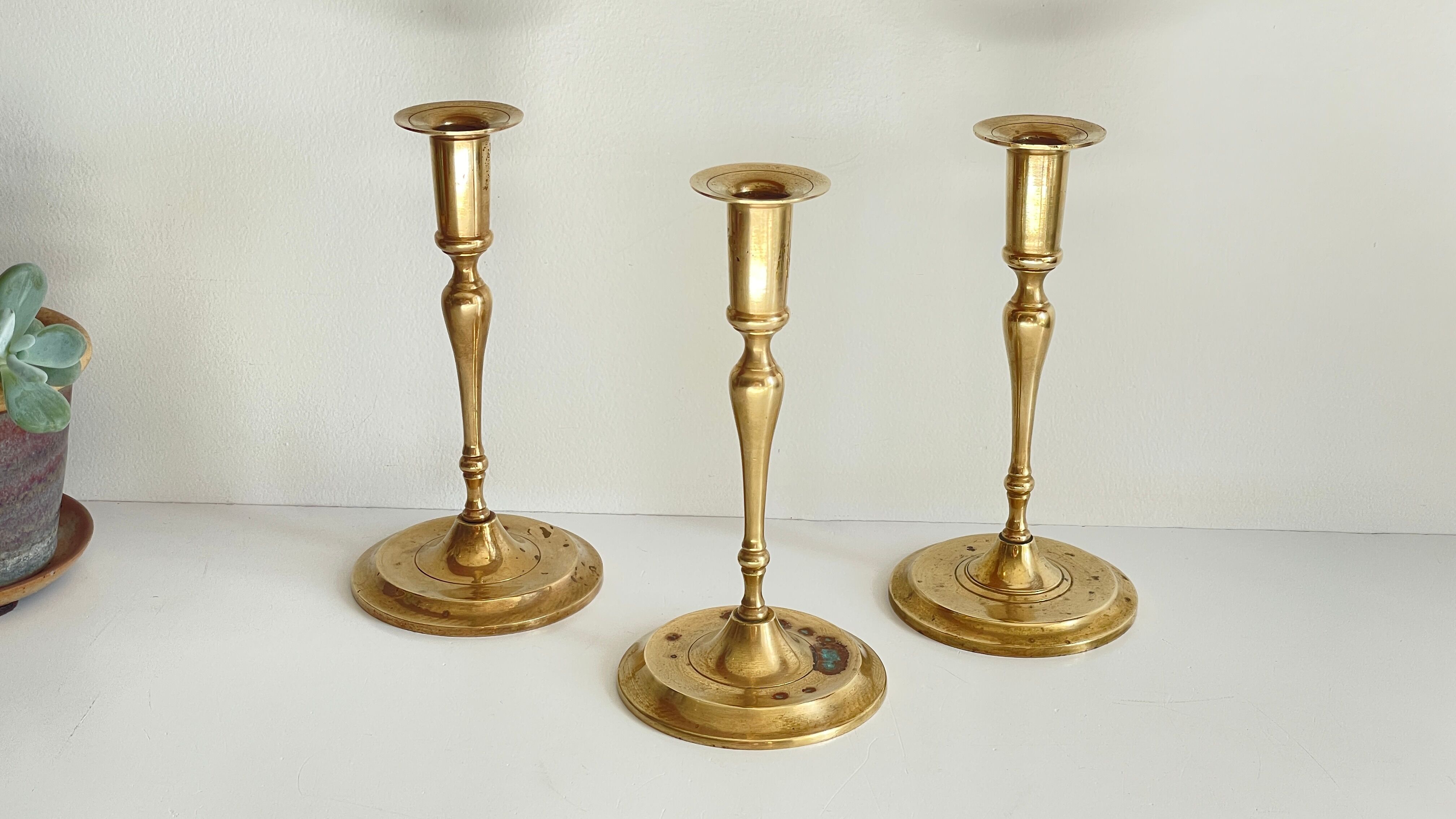 3 patinated brass candle holders