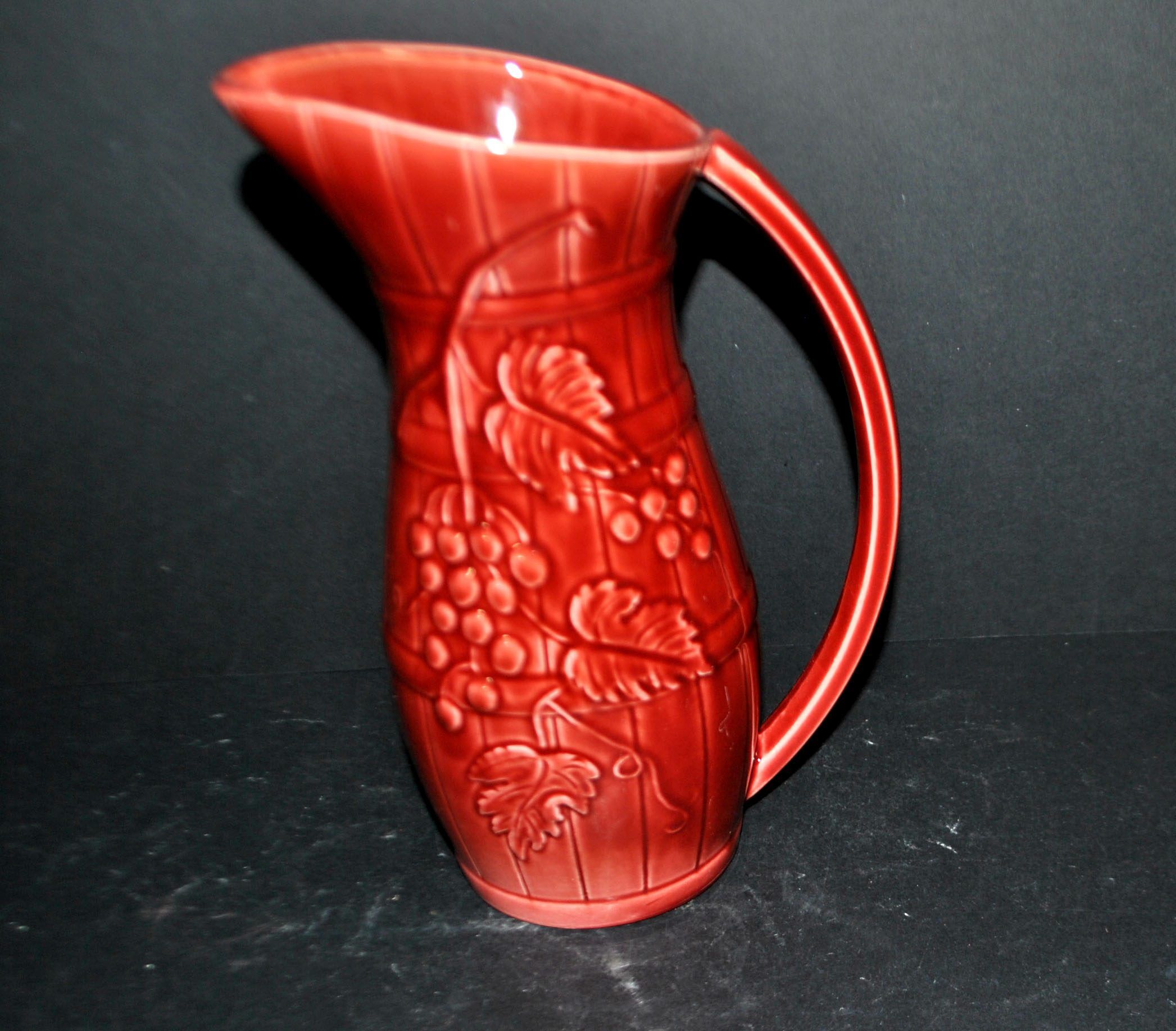 Sarreguemines wine jug in red slipware with grapevine decoration.