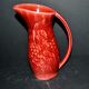 Sarreguemines wine jug in red slipware with grapevine decoration.