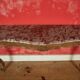 Important console in natural wood, moulded and carved with a red marble top.