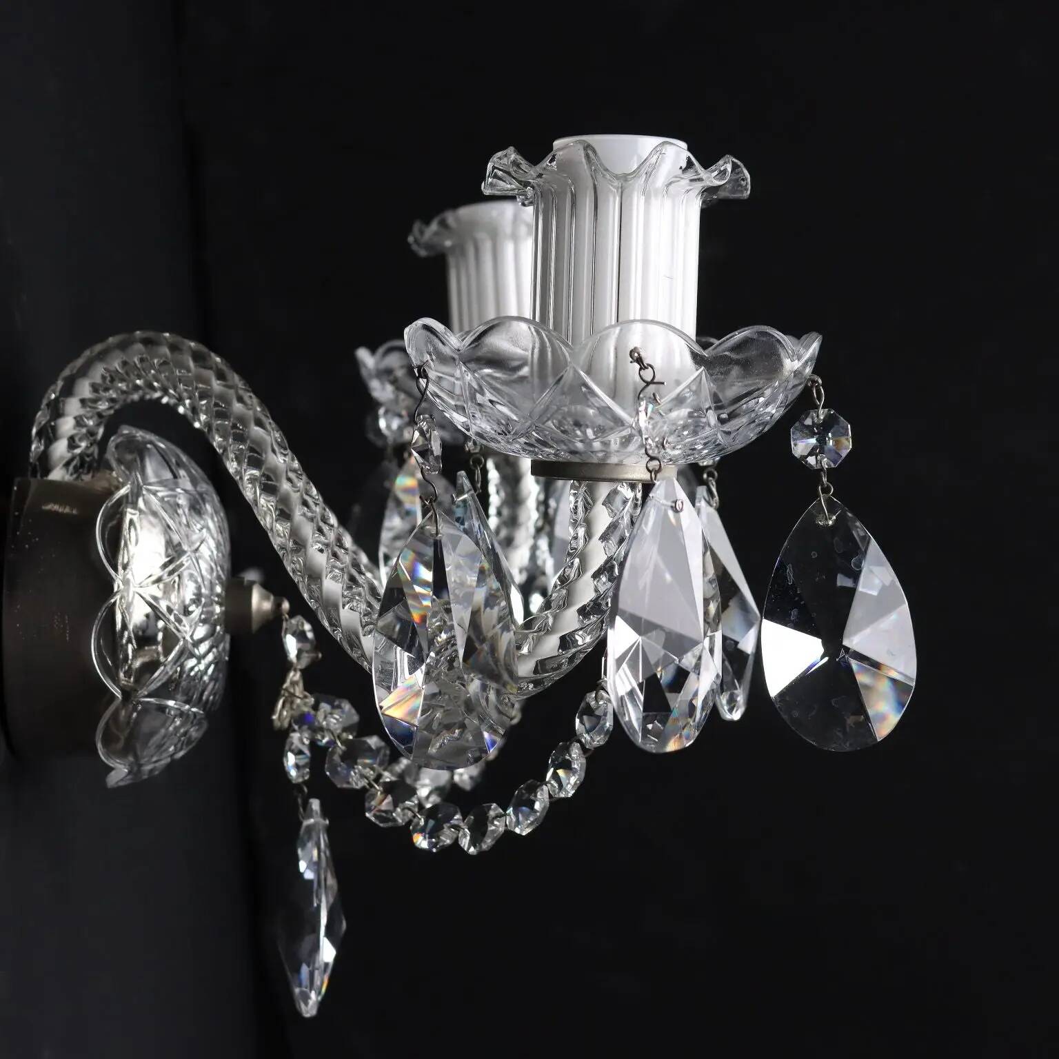 Antique wall light with 2 lights from the 1900s, featuring crystal bobeches and pendants.