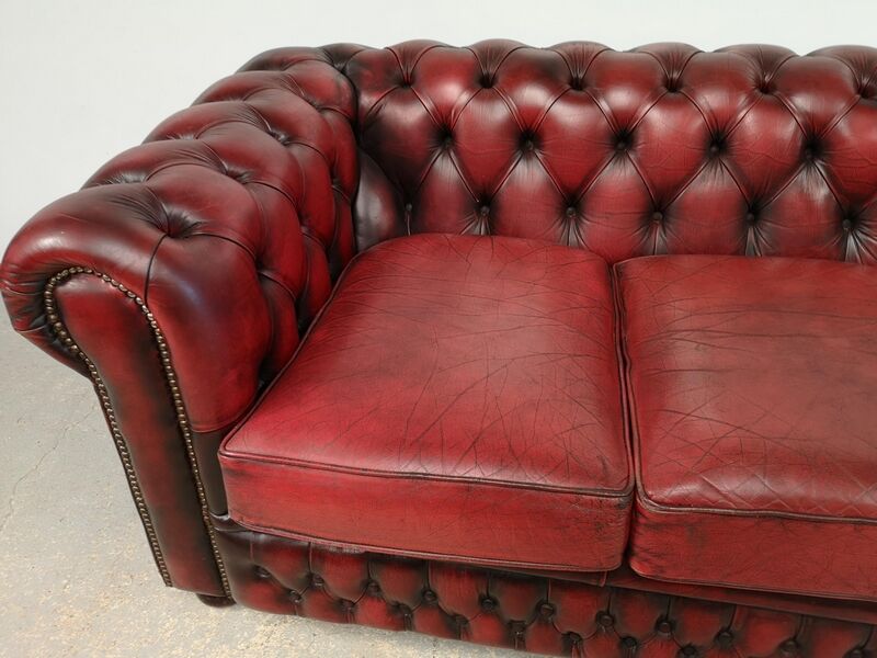 Three-seater red leather chesterfield sofa