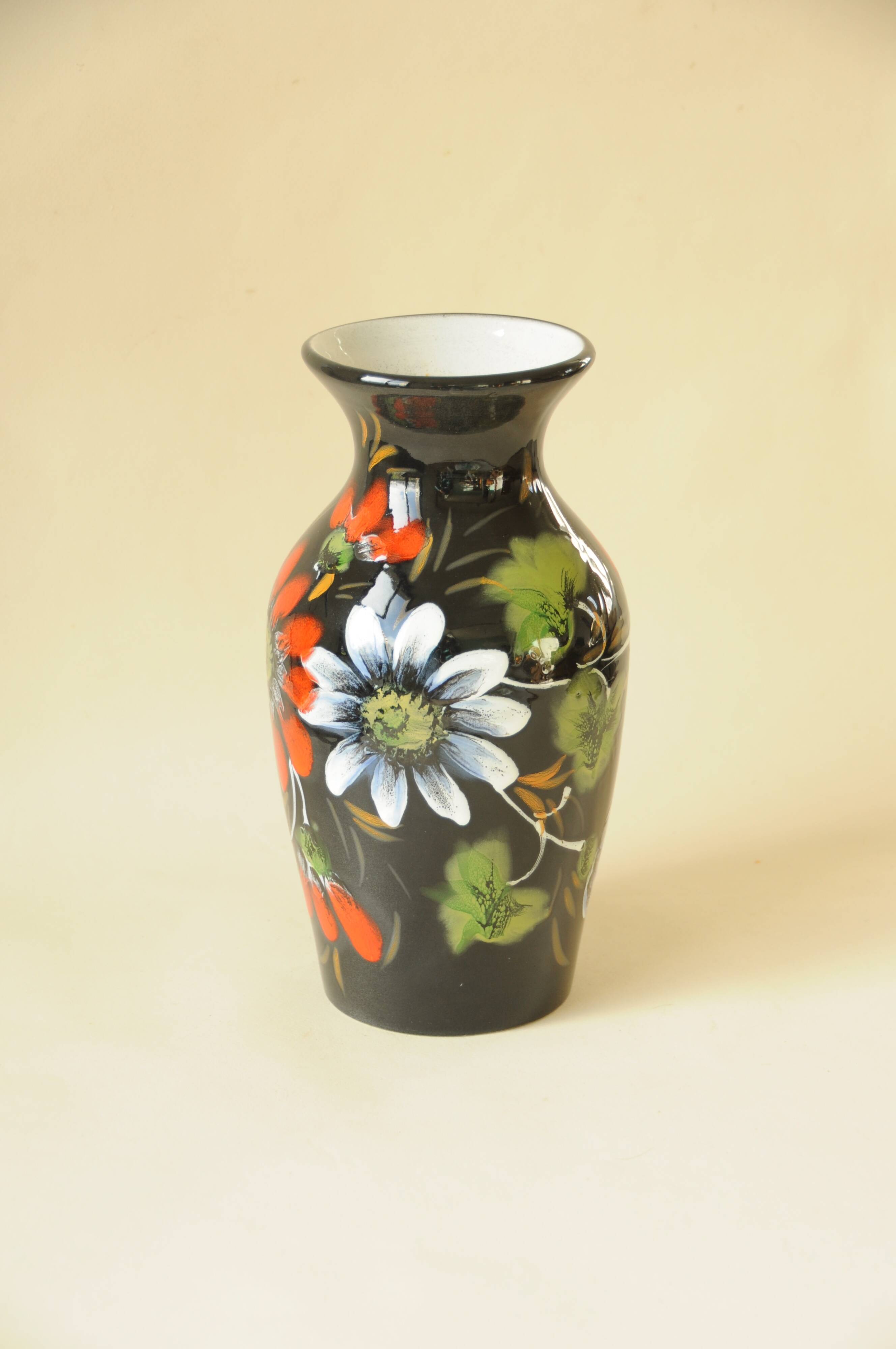 Vintage black ceramic vase with painted floral decoration – stylised colourful flowers.