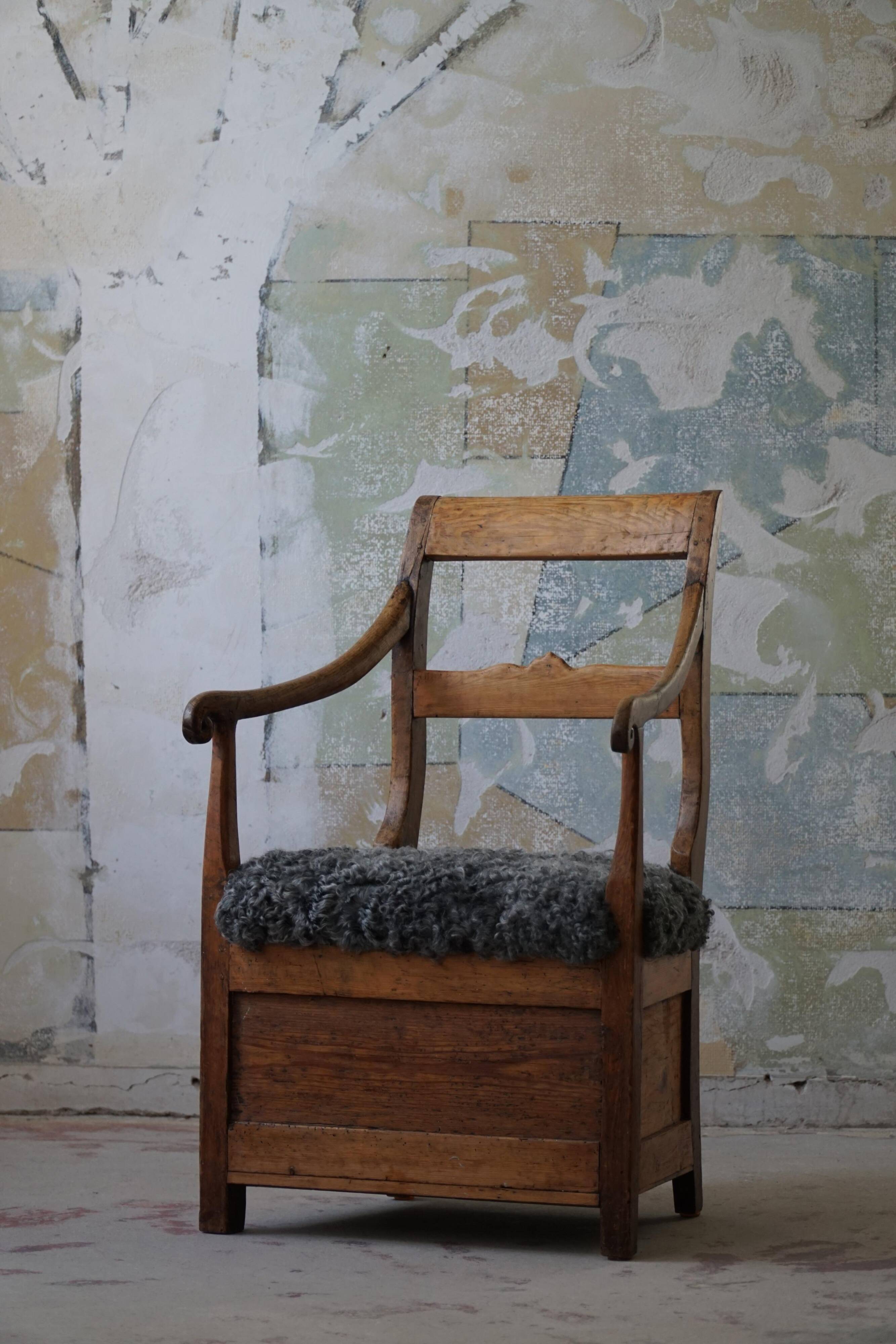 Danish popular art armchair in solid oak and Gotland sheep skin, mid-19th century.