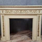 Louis XVI fireplace made in the 19th century, all in lacquered and gilded wood with decorative attributes