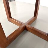 Modernist round table in solid elm, crossed legs.